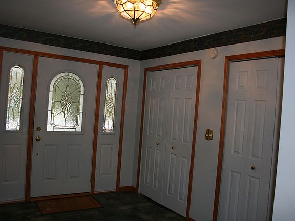 Open entry foyer with ceramic tile floor, large closets