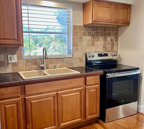 kitchen with new appliances and granite countertops