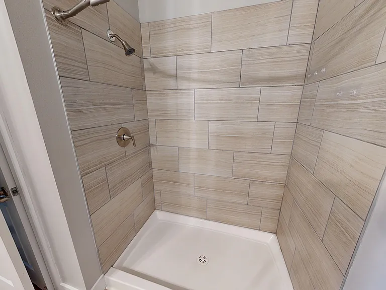 Sling Station's primary en suire bathroom includes a standing shower. Sling Station's primary en suire bathroom includes a standing shower.