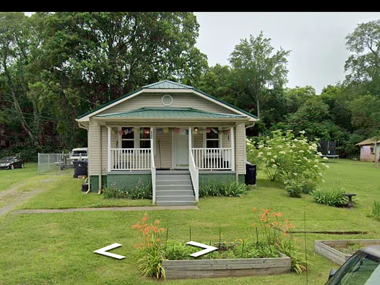 Front of house with two raised beds
