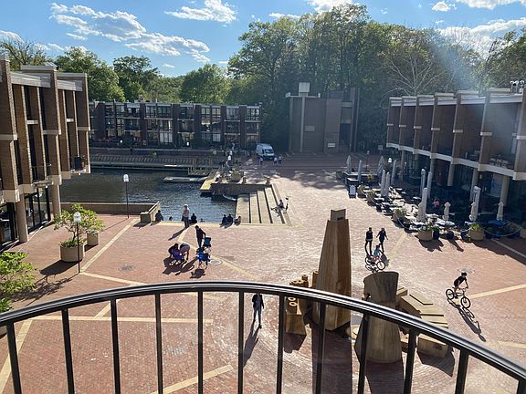 French doors overlook the plaza. Lake and fountain.