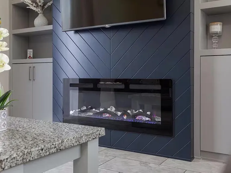 Stylish common area with built-in shelving and a sleek electric fireplace feature wall for relaxing and entertaining.
