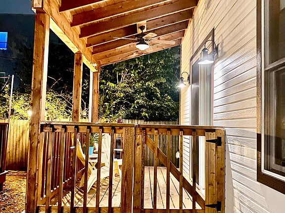 Enclosed & Gated Side Porch off Oversized Sliding Glass Door from Living Room with Direct Access to Side Dog Run. Dimmable Exterior lights and Ceiling Fan