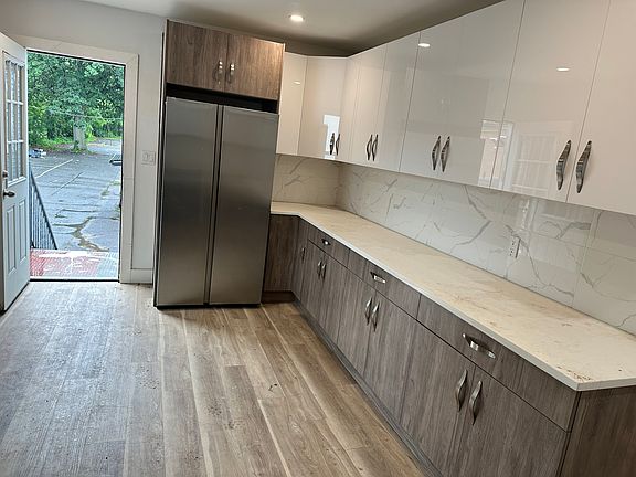 Freshly renovated kitchen with direct access to newly installed back Steel Stairs to Parking lot. Conveniently unload groceries from Car directly to kitchen, via back stairs.
