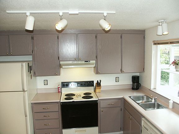 kitchen with lots of cabinets and garden window