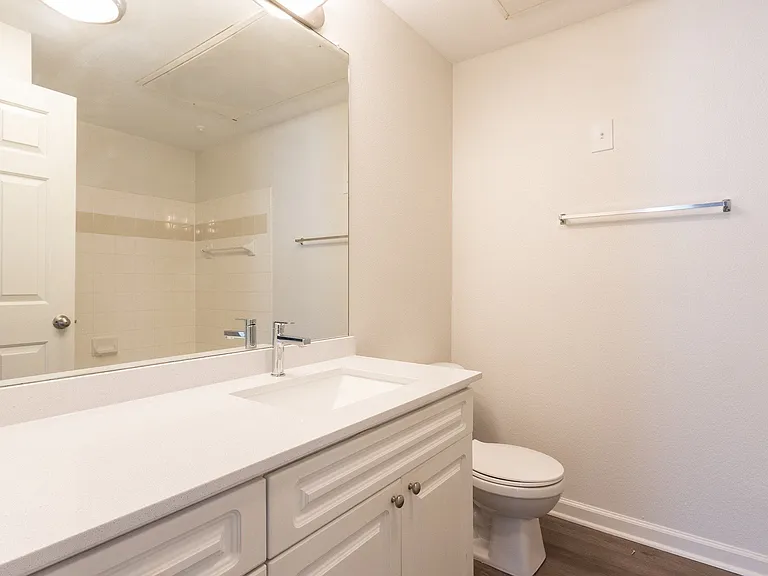 Newly renovated bathrooms are complete with large mirrors and modern finishes