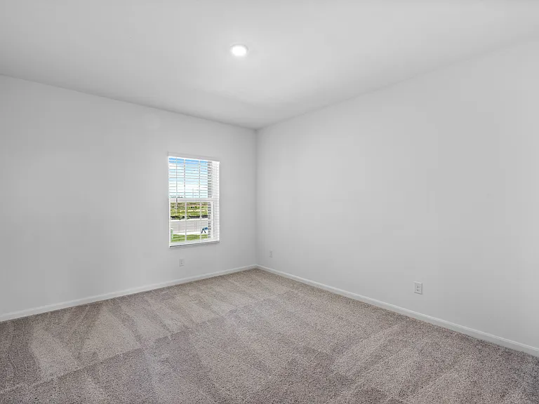 Downstairs master bedroom with carpet.