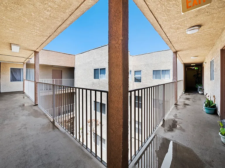 Open-air walkway with views of the interior courtyard and easy access to units.