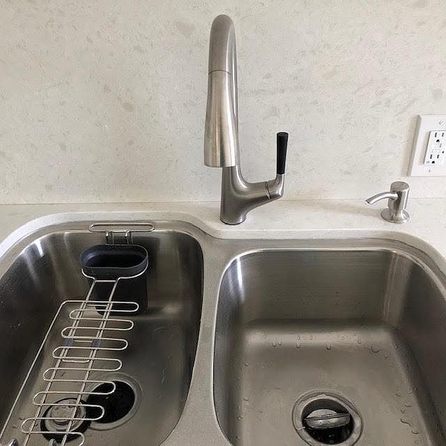 Brand new kohler double sink and faucet equipped with a garbage disposl.