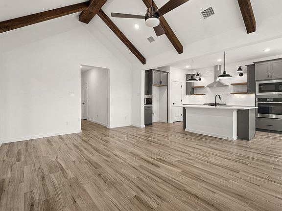 Stunning stained ceiling beams highlight vaulted ceiling