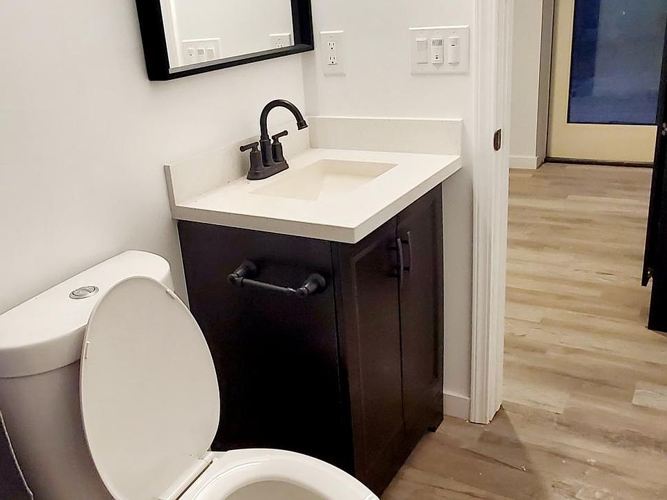 Walk in shower, dual flush toilet, vanity and vanity mirror