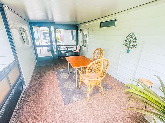 Walk in to an enclosed screened porch.