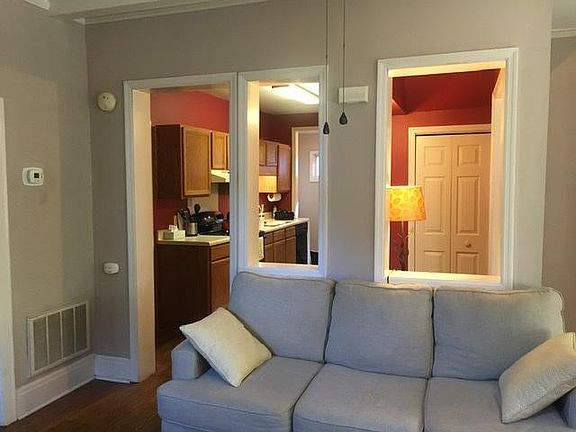 View from living room through breakfast nook and kitchen to back entry