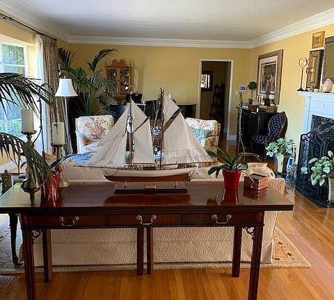 Living room with baby grand piano and big bay window