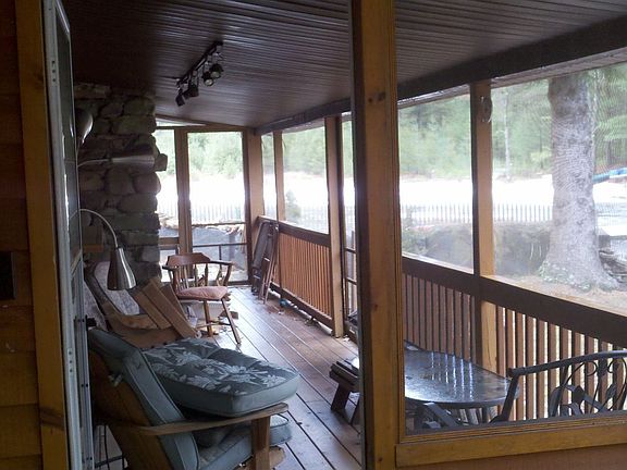 Screened in porch overlooking waterfall