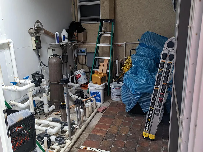 Just off the outdoor kitchen, this is the pool and irrigation room - designed to keep unsightly but necessary tools and equipment out of view. It is accessible from the outside, ensuring pool maintenance staff have no need to enter the home to perform rou