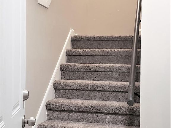Stairway to upstairs bedrooms & bathroom.