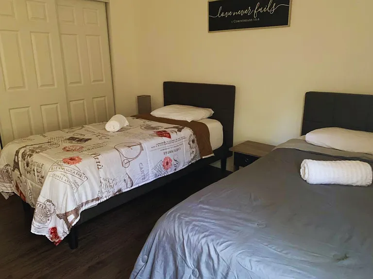 Two Cozy Twin Beds with Premium Linens & Ceiling Fan.