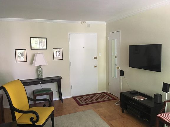 View of front door and wall mounted television