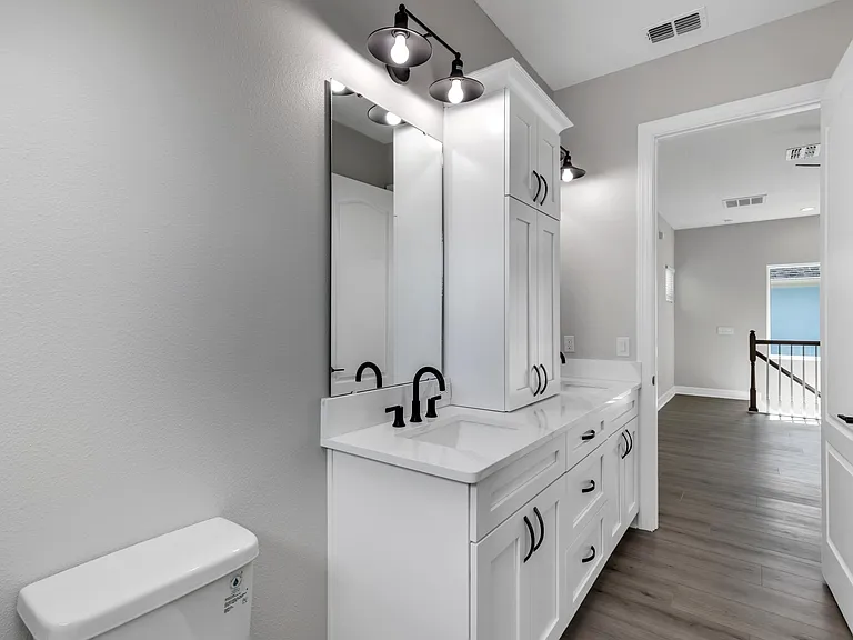 Bathroom double sinks and cabinets.