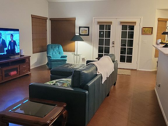 View of living area upon entering from front door entry hall. Kitchen to the right, french doors go out to large covered porch.