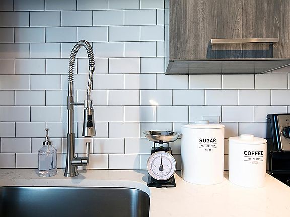 Subway tiling back splash in kitchen