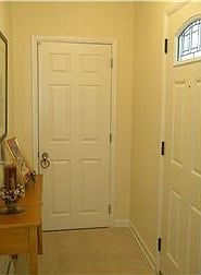 Foyer with coat closet for storage.