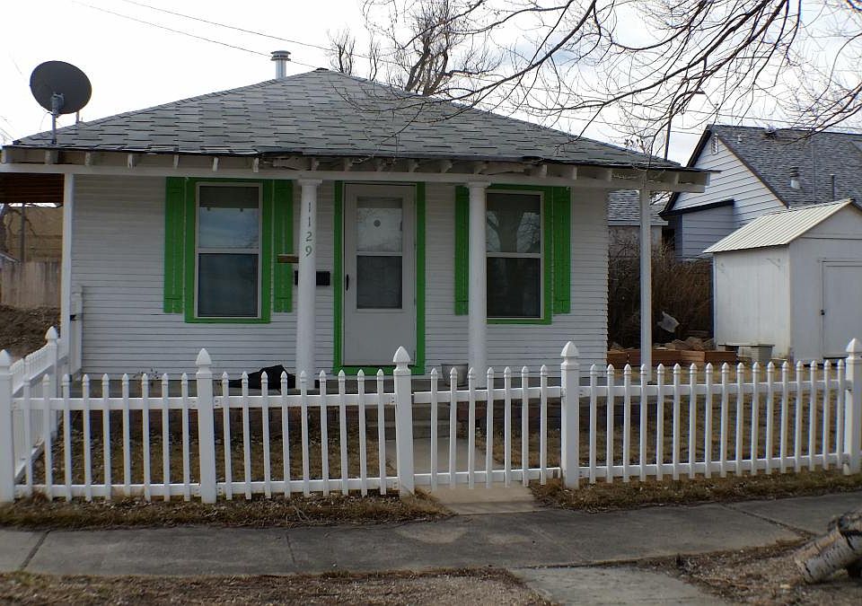 House with carport left and shed right.