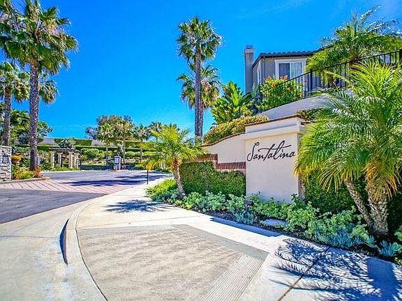 Gated Community Entry with Lush Tropical Landscaping