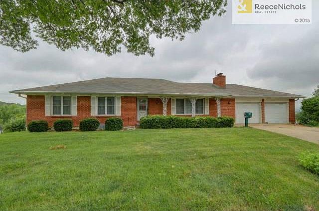Front view of all brick home with 2-car garage.