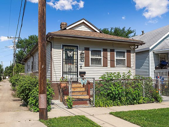 Alley access to the back yard is convenient for gardening and patio furniture.