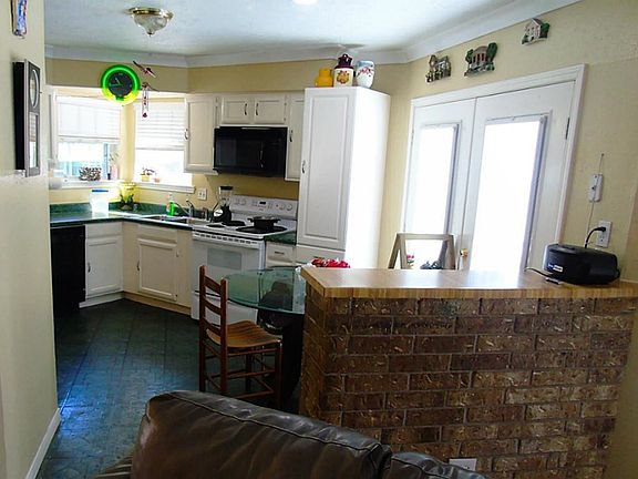 Kitchen with brick accent breakfast bar.