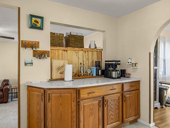 brand new quartz counter tops on this little coffee bar area over looking the large living room area
