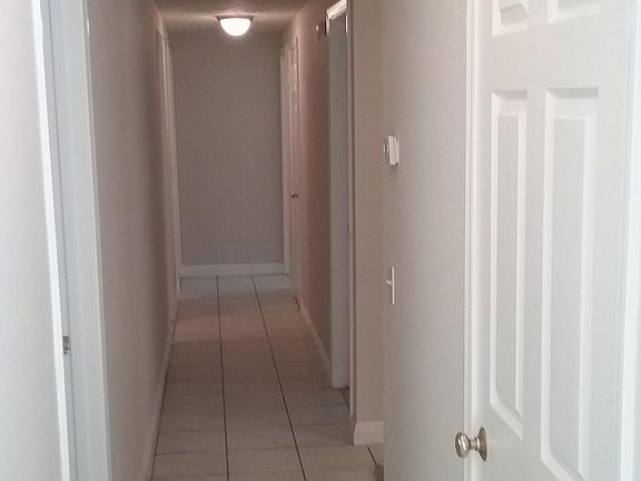 Hallway leading to bedrooms, middle bath, linen closet and storage closet.