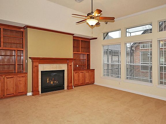 Large living room with high ceiling and view of the courtyard.