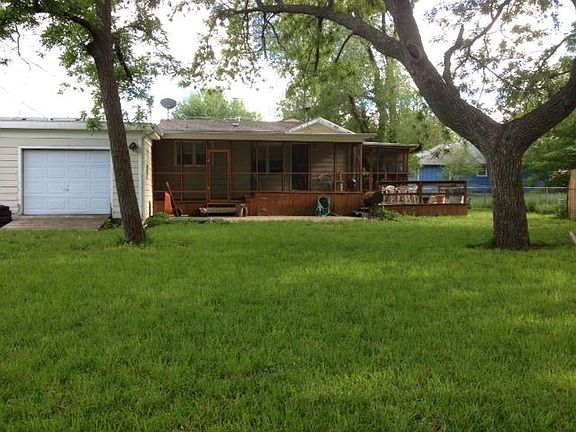 View of Back grilling deck, two screened porches, and drive through garage door