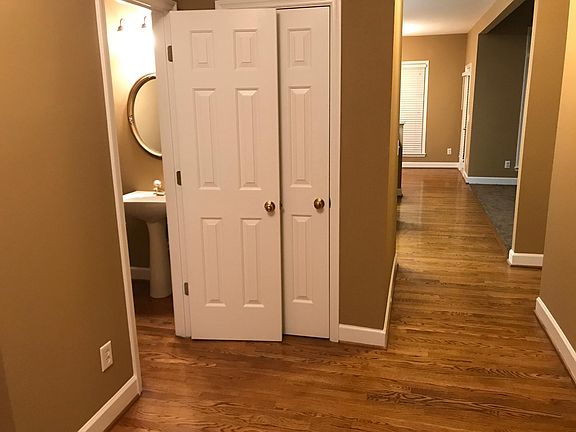 Entry foyer looking toward kitchen. 1/2 bath and coat closet on the left.