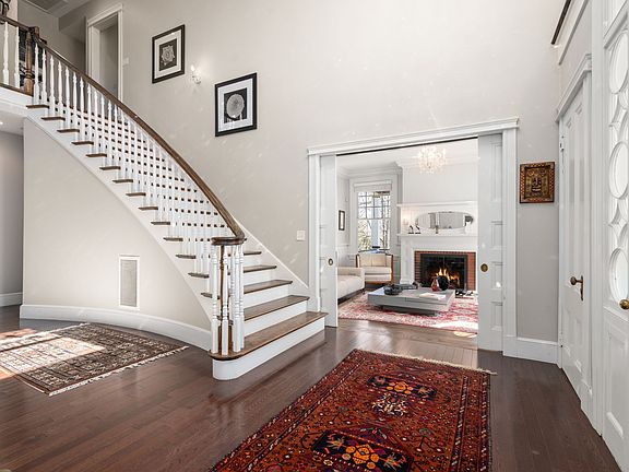Charm! Main entry opens to formal living room and center hallway with bridal stairway to the second floor.