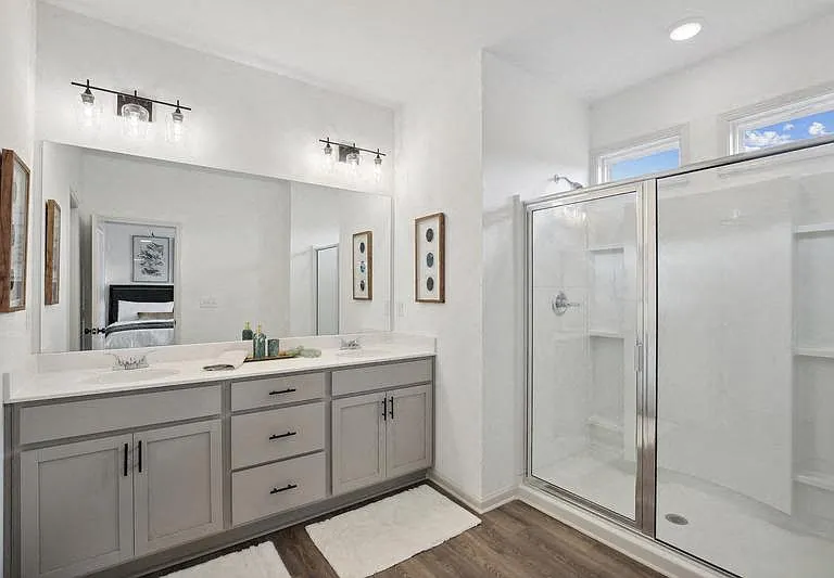 Primary bathroom with double vanity, and walk-in shower.