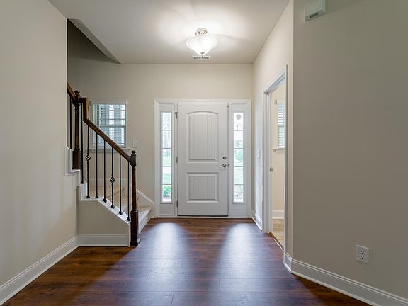 Front entryway with half-bath pictured on right.
