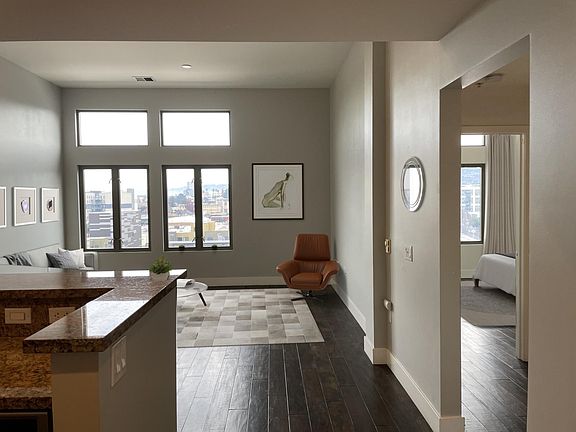 large living room with tall ceilings and views to Oakland hills