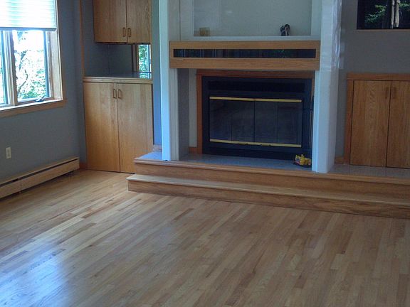 Other half of living room/fireplace, hard wood flooring.