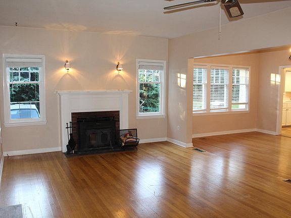 Living and dining area with view into kitchen. Original Hardwood floors throughout most of home.