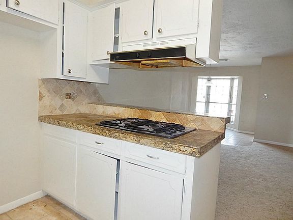 View of kitchen bar that opens to living room area