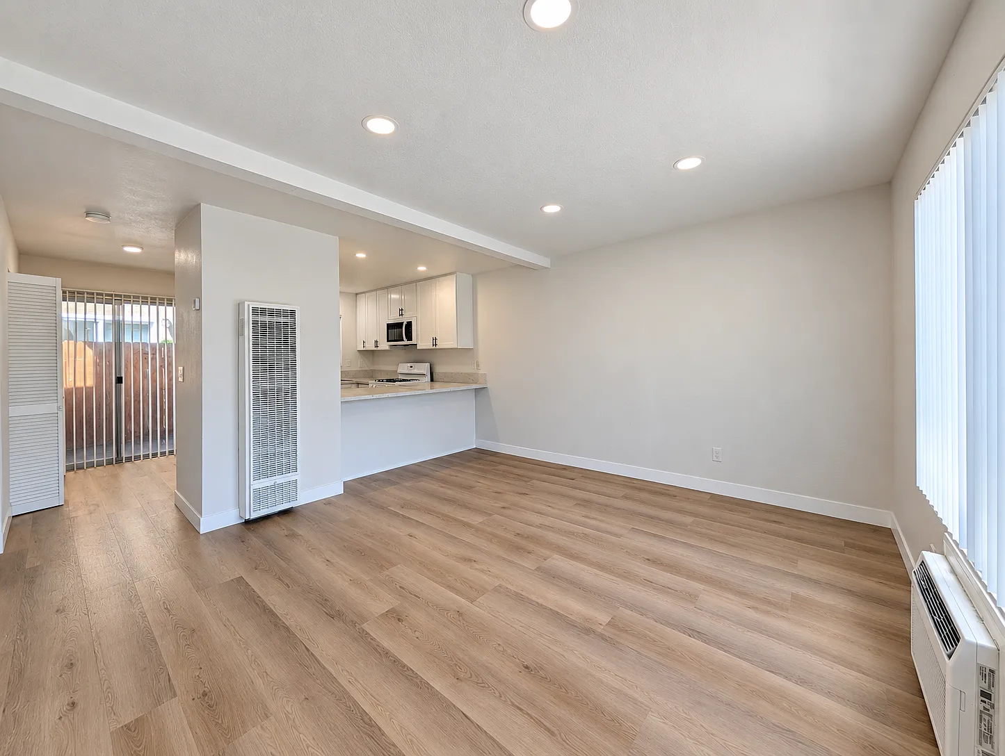 Living room with new flooring, paint, and lighting.