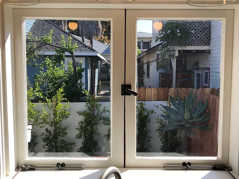 View out the kitchen window looking into the back yard.
