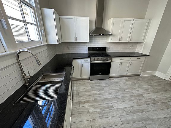 Fully renovated kitchen with granite countertops and all-new stainless steel appliances