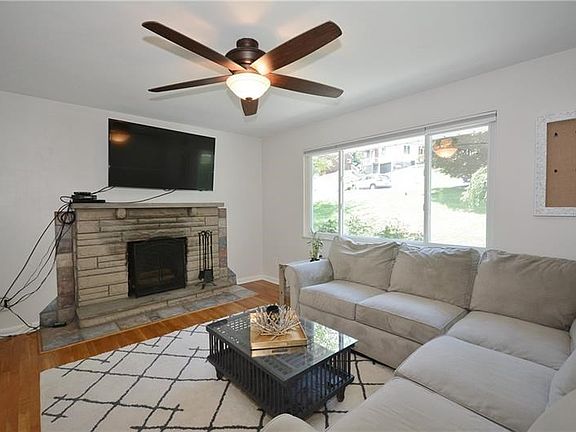 The focal point of the living room is the fireplace. The paddle fan is a recent addition.