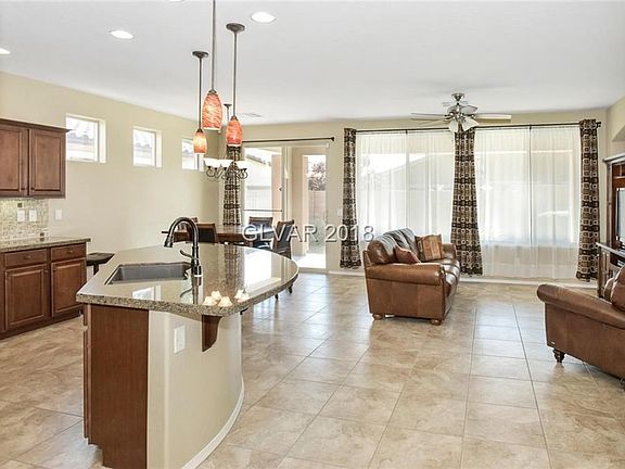 Open greatroom floor plan. Kitchen island with breakfast bar & pendant lights. Upgraded bronze plumbing fixtures & sink.