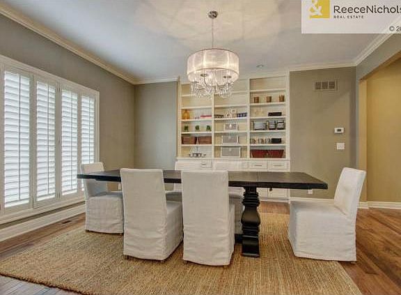 Dining Room features built-in cabinetry, upgraded lighting and p